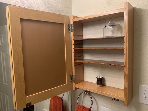 Medicine cabinet interior with adjustable shelving